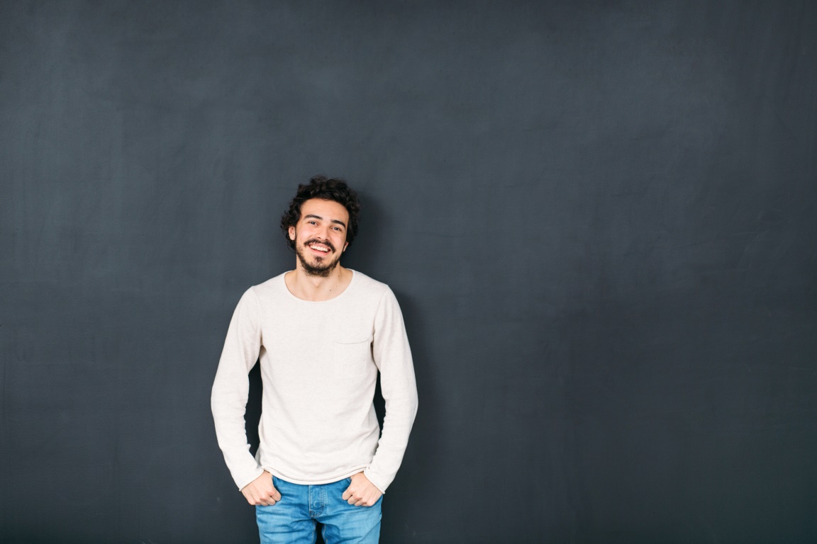 Man in front of chalkboard.