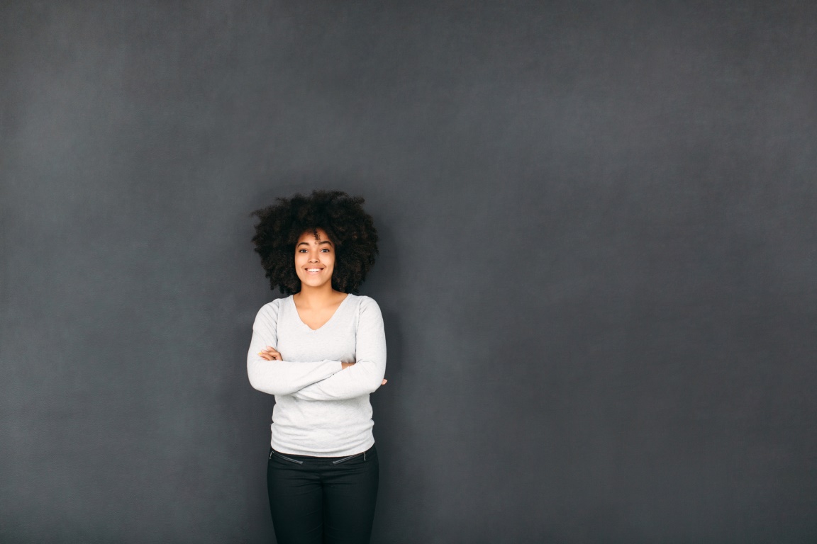 Woman in front of chalkboard.