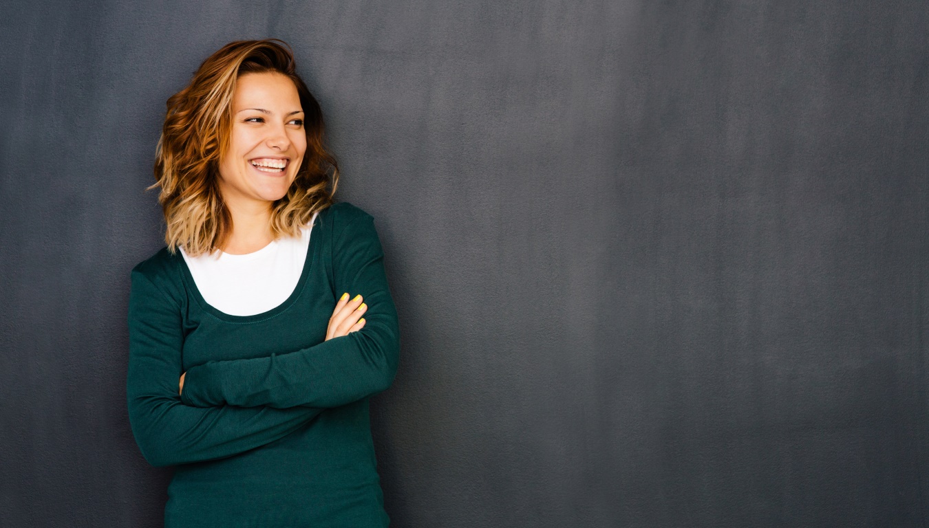 Primary teacher standing in front of chalkboard.